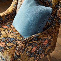 Morris & Co Spring Thicket velvet fabric in “Old Fashioned” colourway – rich rust and jewel‑toned large‑scale tulip and foliage design on cotton‑rich velvet, ideal for drapes, upholstery, headboards or cushions.
