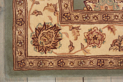 Rectangular beige wool rug with brown floral medallions and ornate border, teal accents; traditional oriental style.