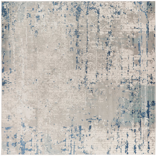 Abstract distressed beige and blue area rug with painterly textures for modern contemporary floor decor.
