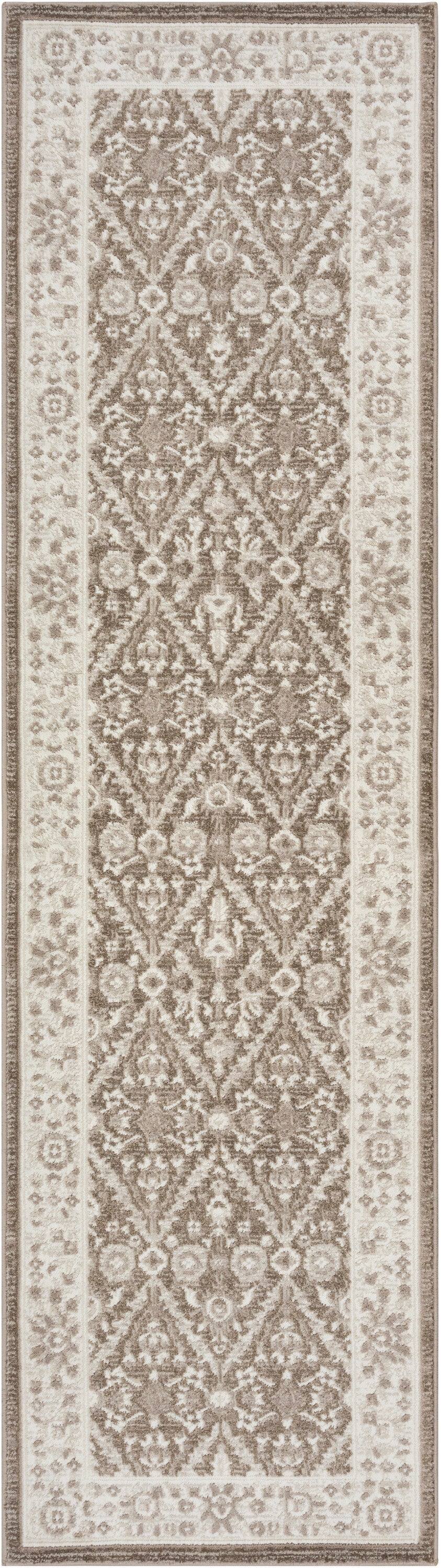 Rectangular oriental-style rug in cream and taupe with a repeating floral damask in the center and bordered edges.