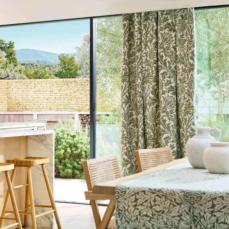 Morris & Co Thistle Weave fabric in Nettle featuring a classic botanical thistle pattern with woven texture, designer upholstery fabric suitable for cushions, curtains, blinds, occasional upholstery and general upholstery for indoor or outdoor décor projects.
