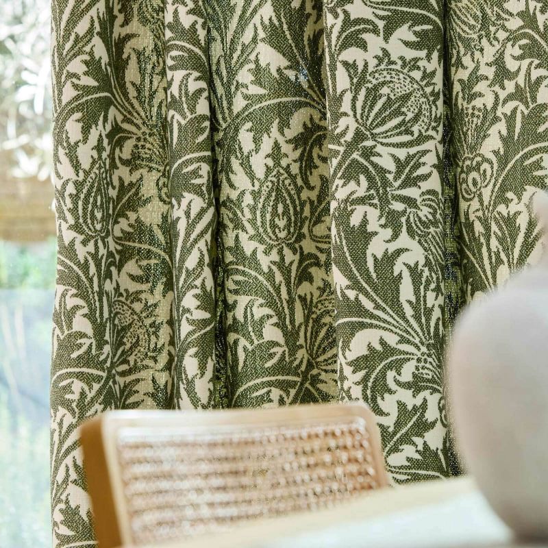 Morris & Co Thistle Weave fabric in Nettle featuring a classic botanical thistle pattern with woven texture, designer upholstery fabric suitable for cushions, curtains, blinds, occasional upholstery and general upholstery for indoor or outdoor décor projects.
