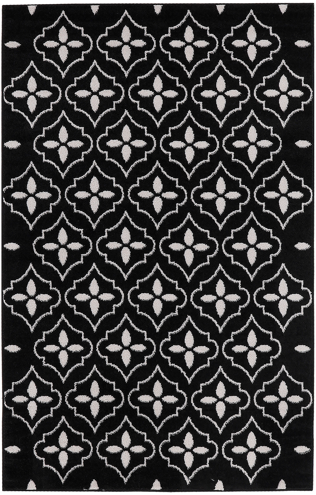 Black rug with white repeating quatrefoil lattice pattern; plush texture, modern geometric decor.