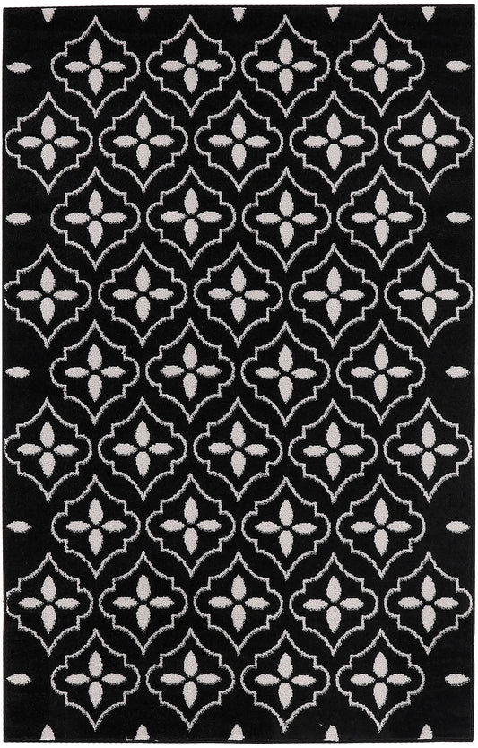 Black rug with white repeating quatrefoil lattice pattern; plush texture, modern geometric decor.