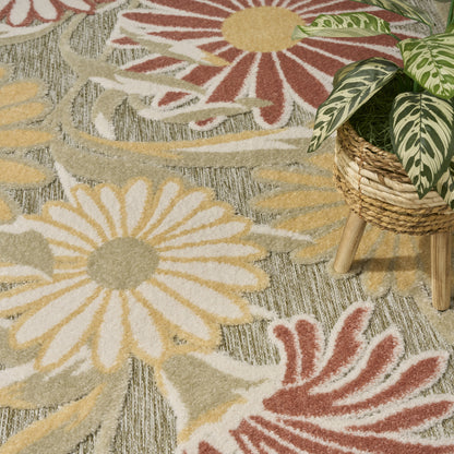 Colorful floral outdoor rug with large yellow and white daisies and red accents.