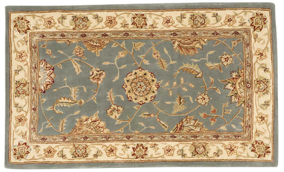 Traditional oriental area rug: blue central field with ivory floral border and beige outer frame.