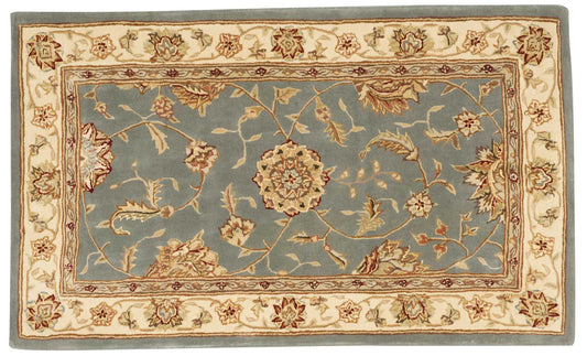 Traditional oriental area rug: blue central field with ivory floral border and beige outer frame.