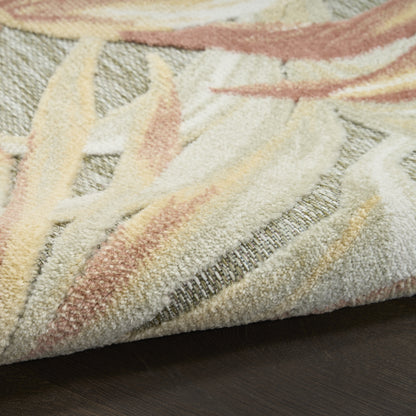 Pastel-toned textured rug with cream, beige, peach and yellow woven fibers, folded on dark wood floor.