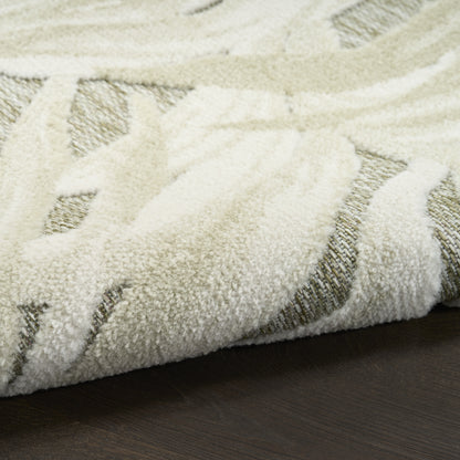 Cream shag area rug with subtle geometric pattern on dark wooden floor; plush, soft pile for living rooms.
