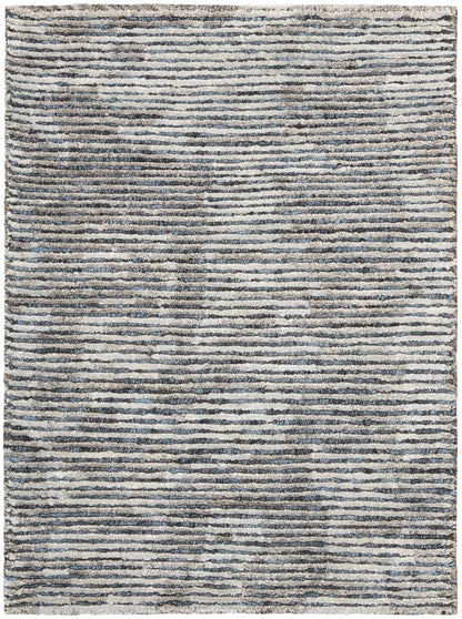Rectangular rug with irregular blue-gray stripes on a cream background; textured, modern, neutral-toned.