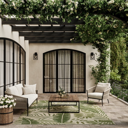 Cream outdoor rug with tropical leaf pattern, 10' x 14'.