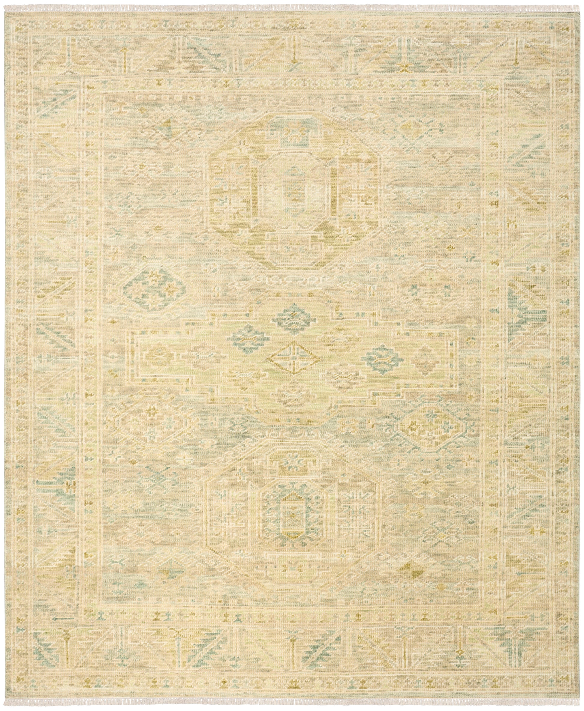 Rectangular area rug in cream with pale sage blue and tan distressed geometric medallion motifs and border.