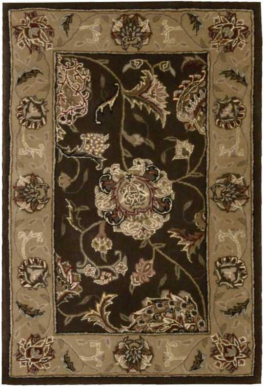 Traditional rectangular rug with dark central field, large pink floral motif, and beige border with scrolling blossoms.