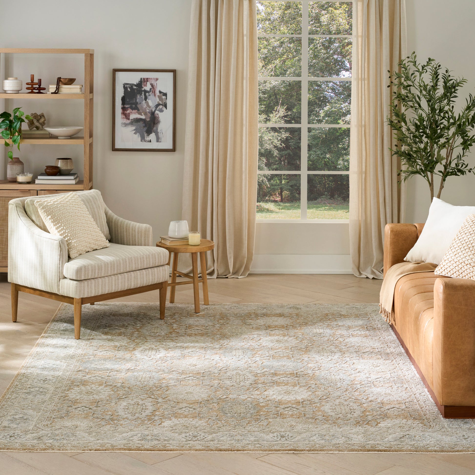 Patterned rug in a bright living room with a cream armchair, beige curtains, window, orange-brown sofa, shelving, and a plant.