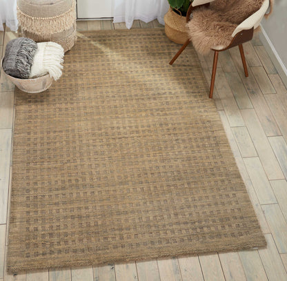Beige jute area rug with subtle checker grid pattern and natural woven texture for boho living spaces.
