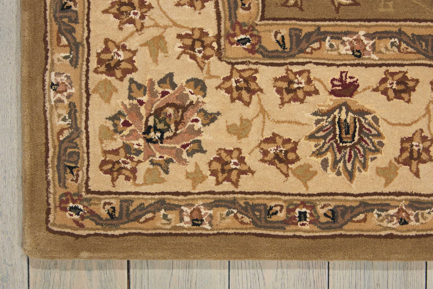 Beige Persian-style runner rug with an ornate floral border and blue accents on a light wooden floor.
