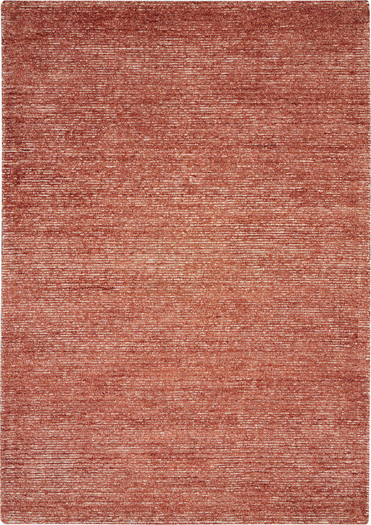 Rust-red woven area rug with subtle marled texture; rectangular modern floor covering.