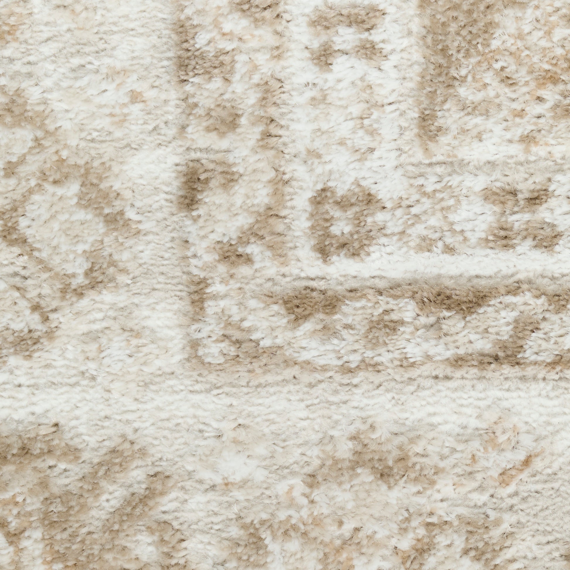 Cream and beige shag rug with plush pile and subtle geometric pattern.
