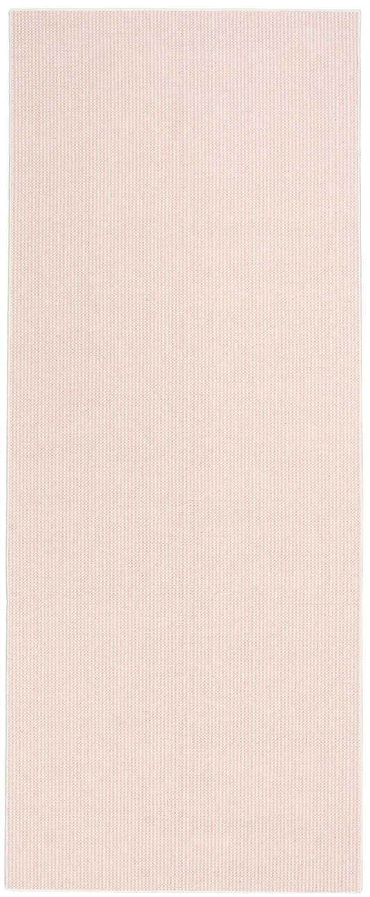 Pink rectangular runner rug with tiny dot texture and white border.