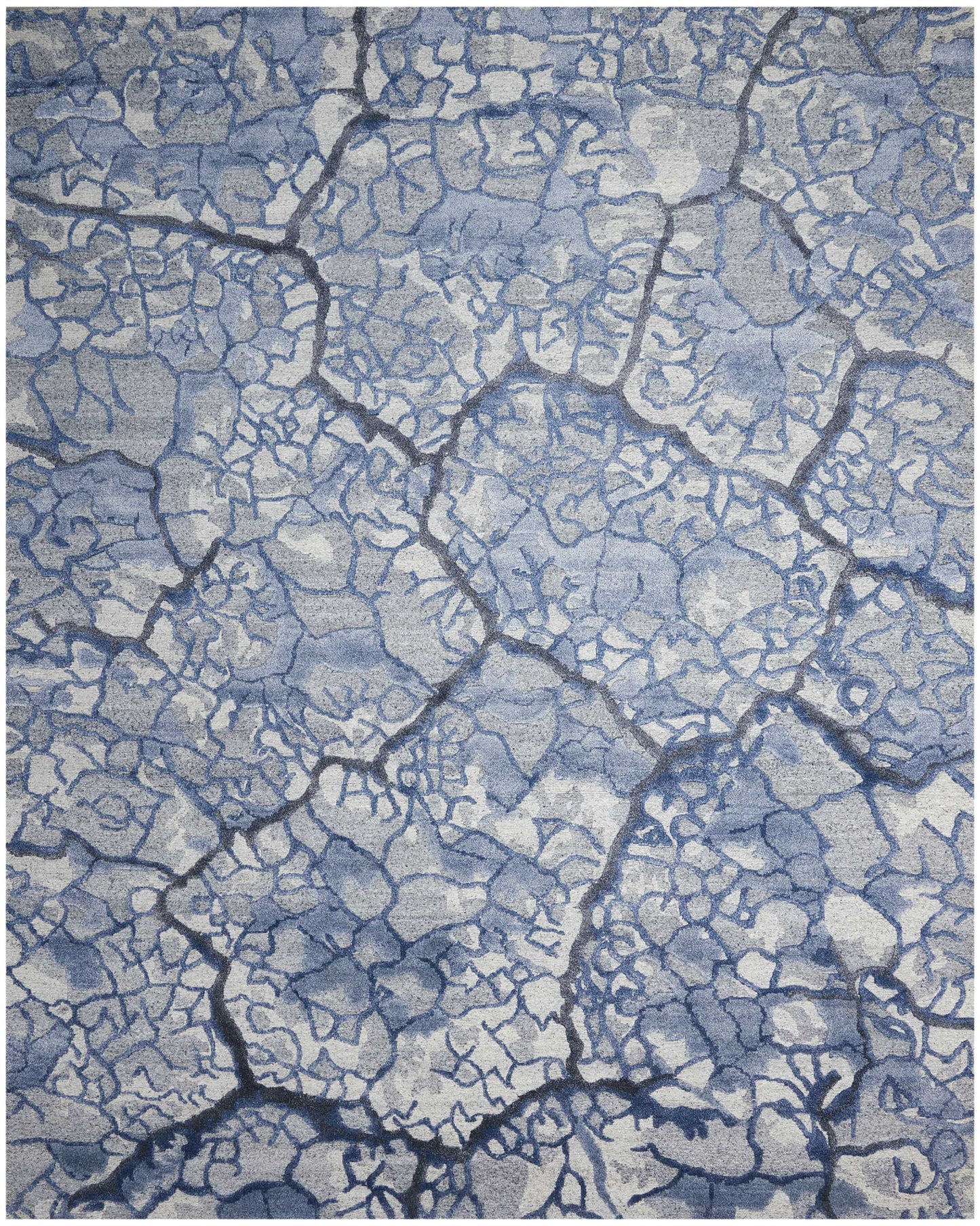 Blue-gray cracked earth texture with bold dark seams; abstract rugged pattern for decor.