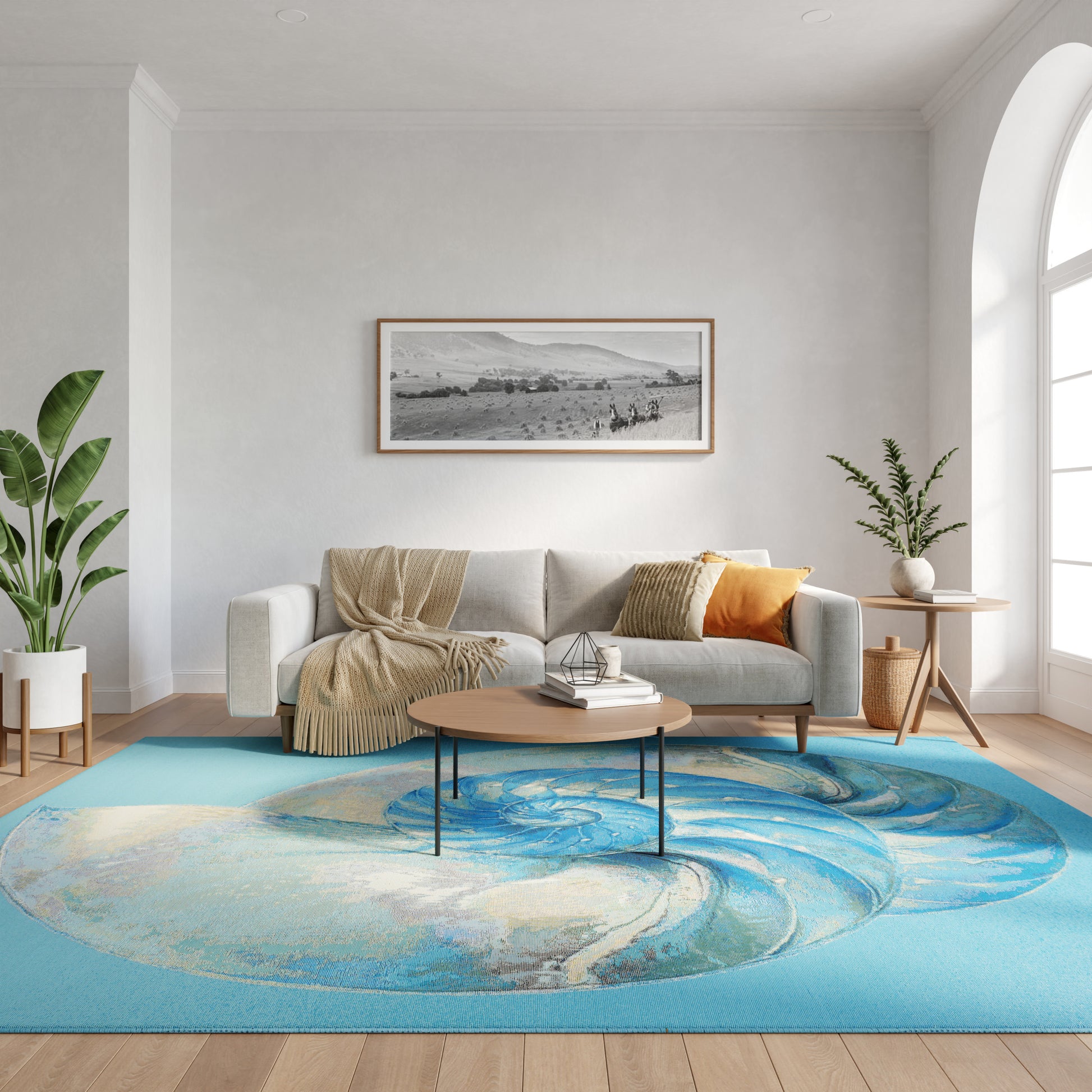 Cozy living room with gray sofa, beige throw, orange cushion, round wood coffee table, blue swirl rug, plants.