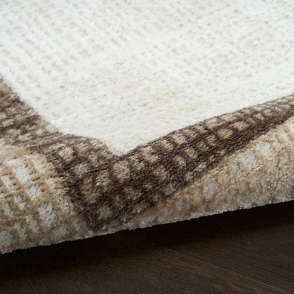 Cream and beige area rug with a brown geometric border; plush pile, rectangular living-room rug, 8' x 10'.