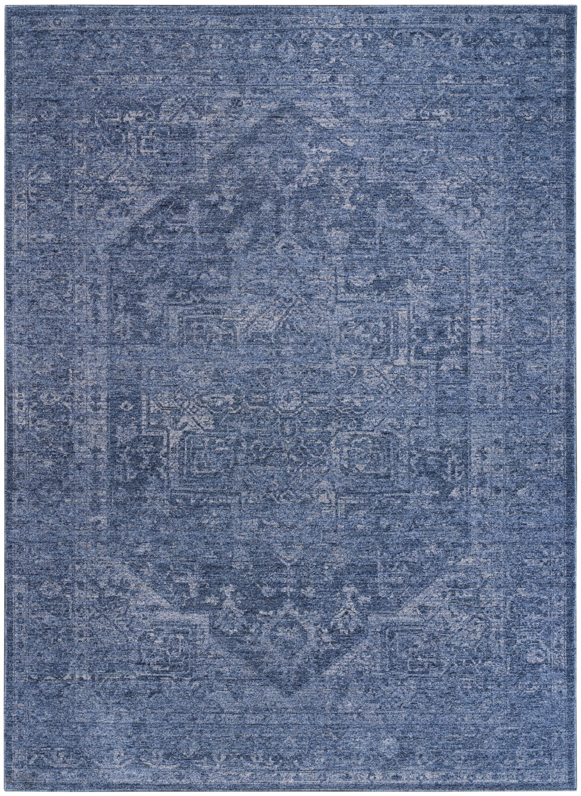 Blue distressed rug with faded Persian-style medallion and ornate border; vintage floor decor.