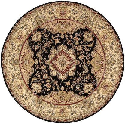 Round Persian-style rug with black central field, gold-beige floral medallions and a wide beige border.