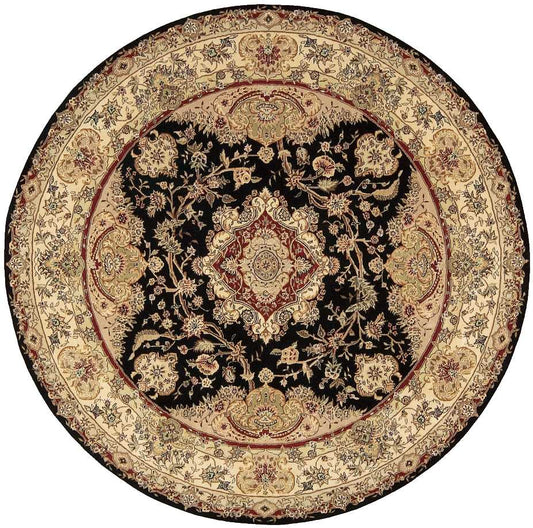 Round Persian-style rug with black central field, gold-beige floral medallions and a wide beige border.