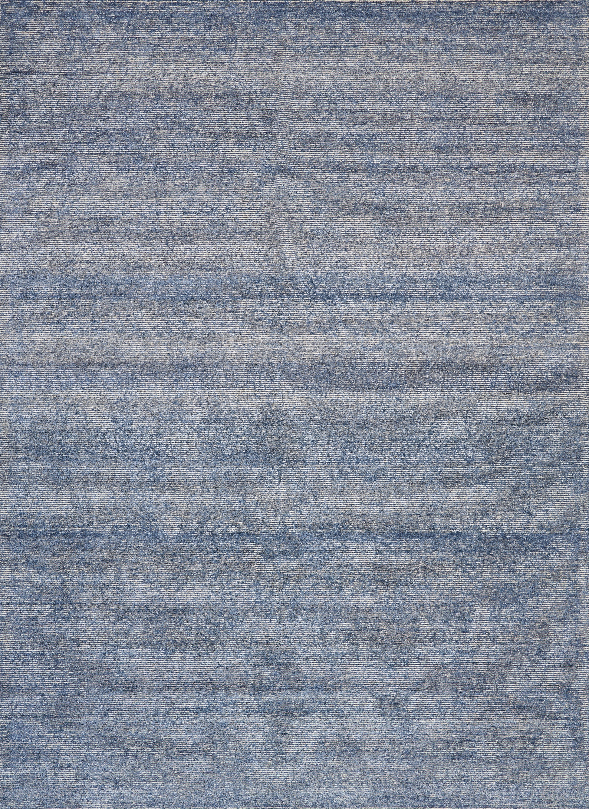 Blue denim-style flat-weave rug with subtle horizontal striations and a soft, casual look.