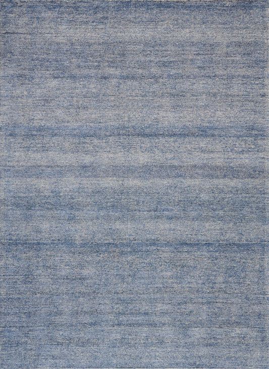 Blue denim-style flat-weave rug with subtle horizontal striations and a soft, casual look.