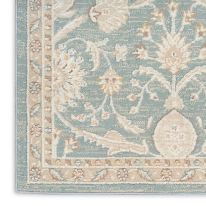 Teal blue woven oriental rug corner with ivory floral damask pattern and beige border.