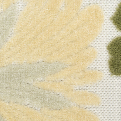 Close-up of a textured rug with pale yellow and light gray leaf shapes on a cream grid background.