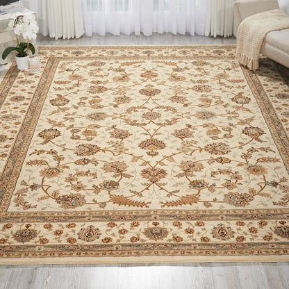 Cream Persian-style area rug with brown floral motifs and blue accents, bordered by an ornate beige frame in a living room.