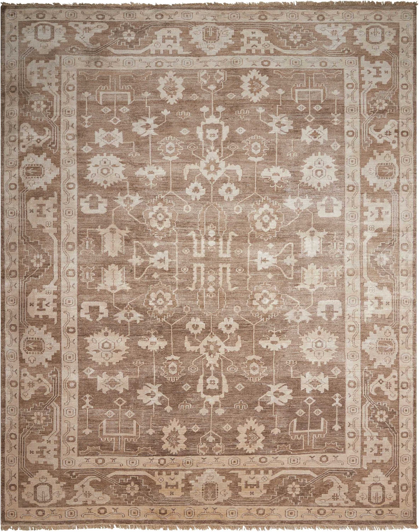 Rectangular beige-brown oriental rug with intricate floral-geometric center and decorative border; vintage distressed.