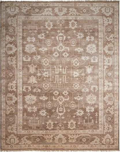 Rectangular beige-brown oriental rug with intricate floral-geometric center and decorative border; vintage distressed.