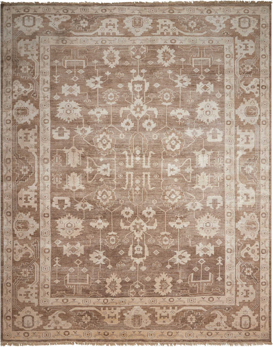 Rectangular beige-brown oriental rug with intricate floral-geometric center and decorative border; vintage distressed.