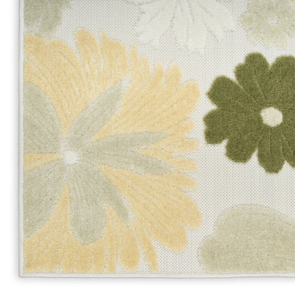 Cream woven rug corner with large pale yellow petals and an olive green flower, textured surface and white edge binding.