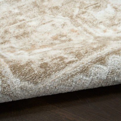 Cream shag rug with thick plush pile and tonal pattern on dark wood floor.
