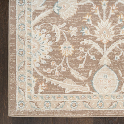 Rectangular brown floral area rug with cream and light blue accents and ornate border on dark wood floor.