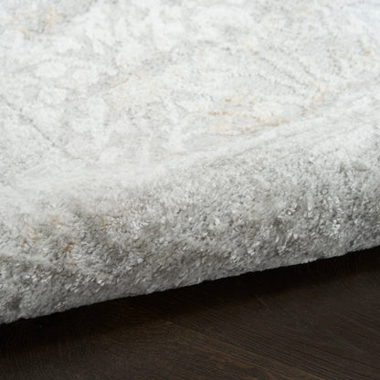 Light gray plush shag rug with a subtle cream pattern on a dark wood floor.