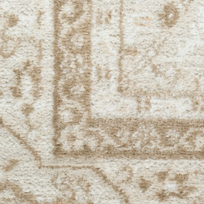 Cream beige shag rug with plush pile and muted geometric border; cozy floor covering.