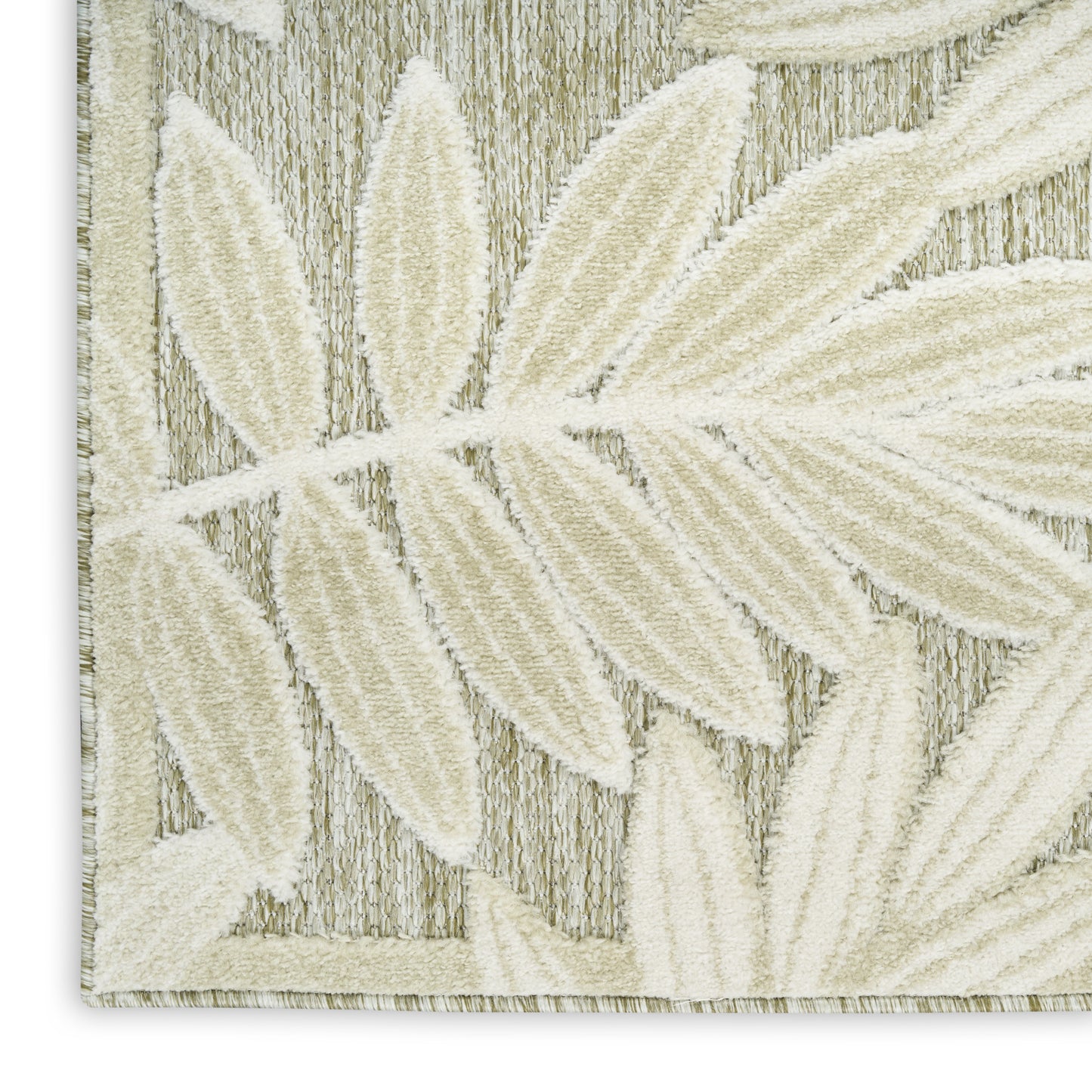 Cream leaf motifs on a beige woven rug; textured, botanical pattern for neutral decor.