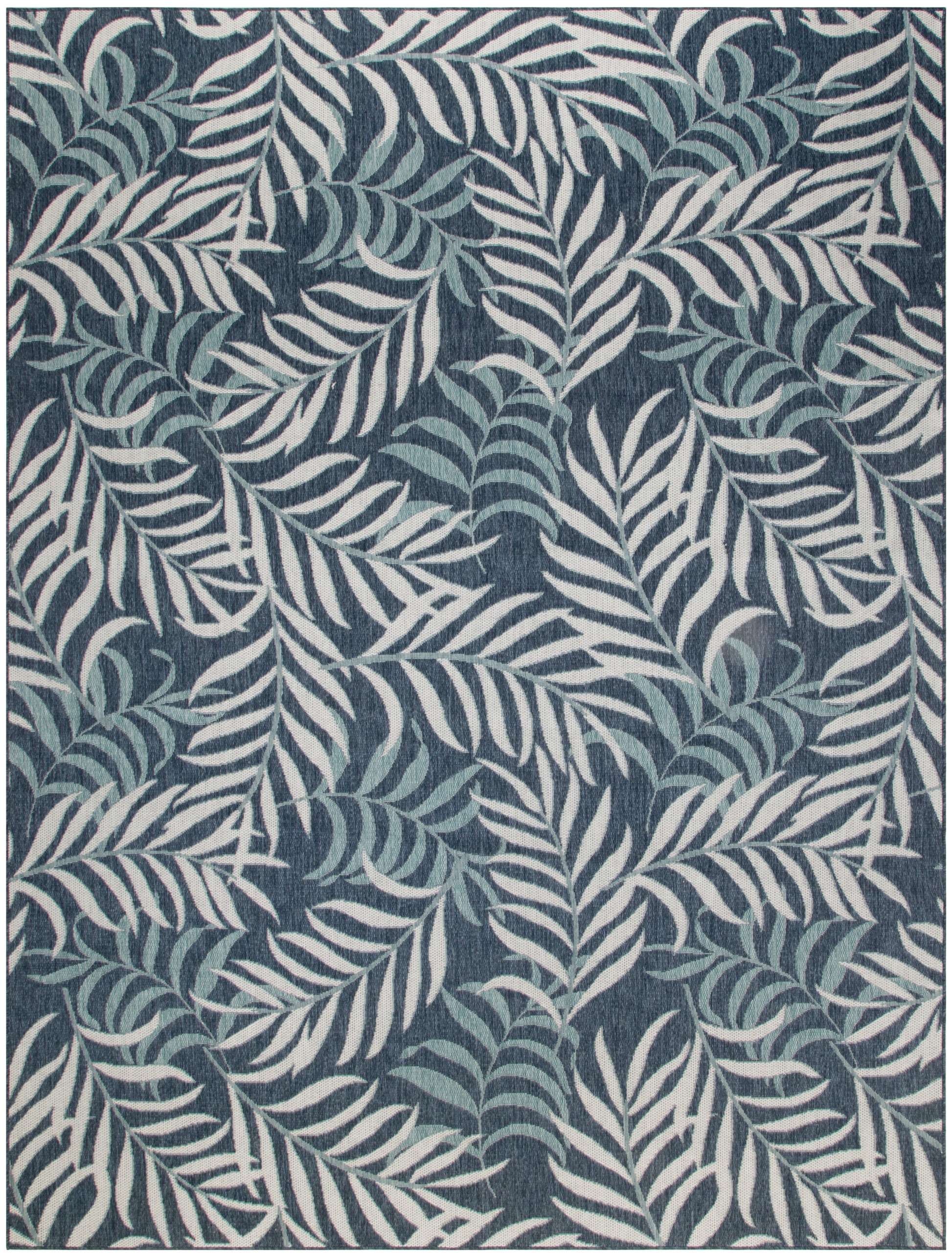 Navy blue rug with white fern leaves; dense botanical pattern for modern tropical decor.