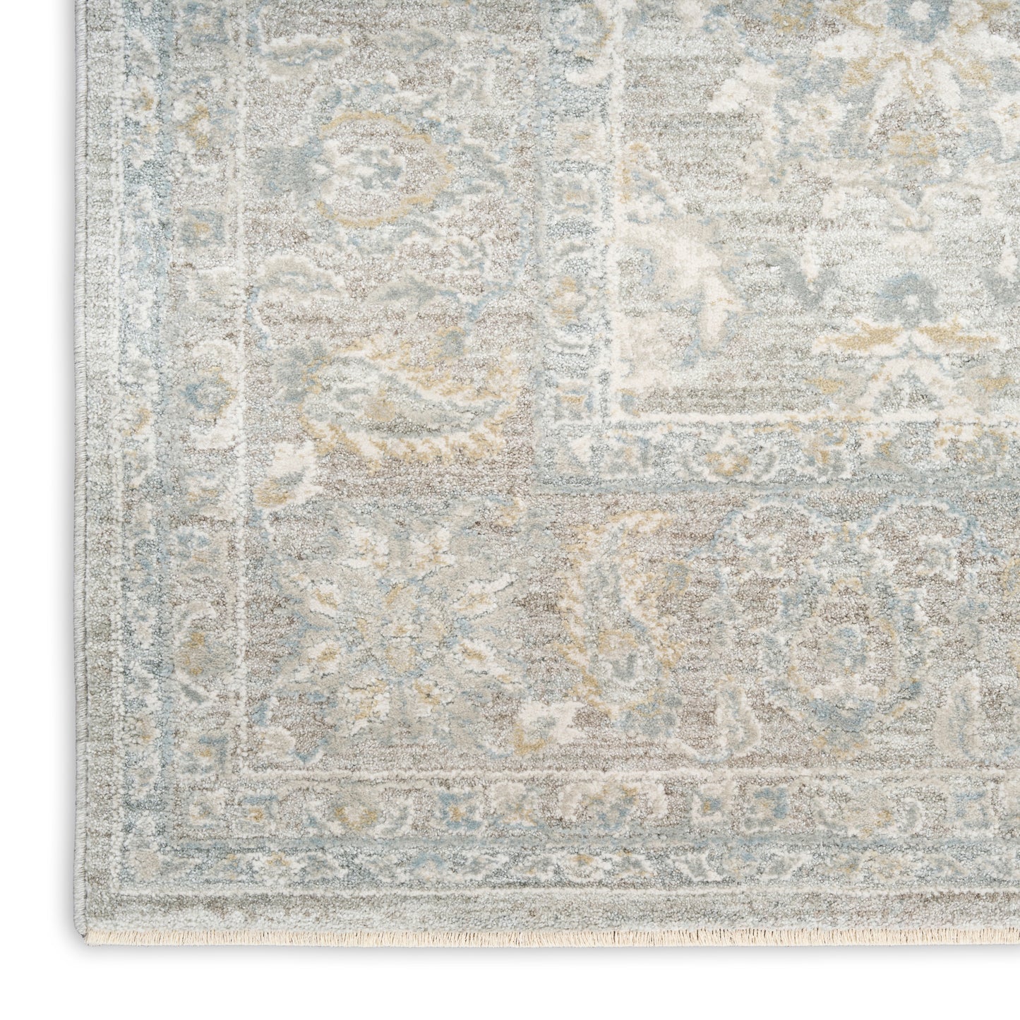 Distressed blue-gray oriental rug with beige floral patterns and ornate border, cropped corner.