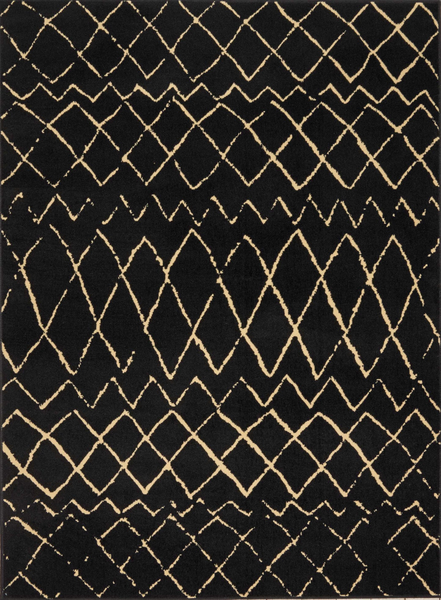 Black rug with cream diamond lattice pattern; geometric, woven boho style decorative floor covering.