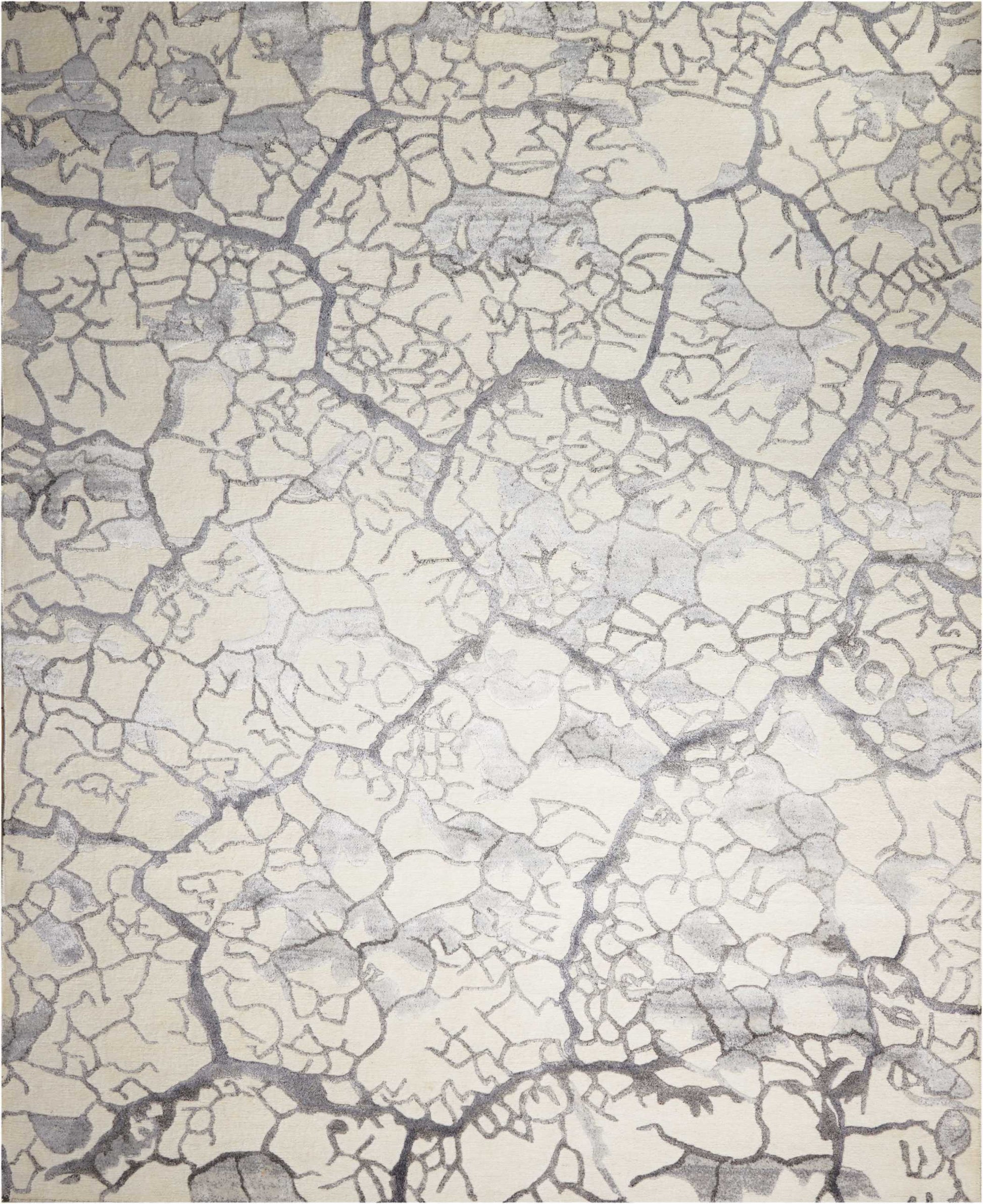 Beige cracked-earth texture with gray crevices; abstract rugged pattern for wallpaper, fabric or rug.