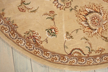 Beige oriental rug edge with intricate floral pattern and decorative border in cream, brown and red.