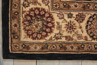 Rectangular Persian-style rug with cream, tan and burgundy floral motifs and a black border.