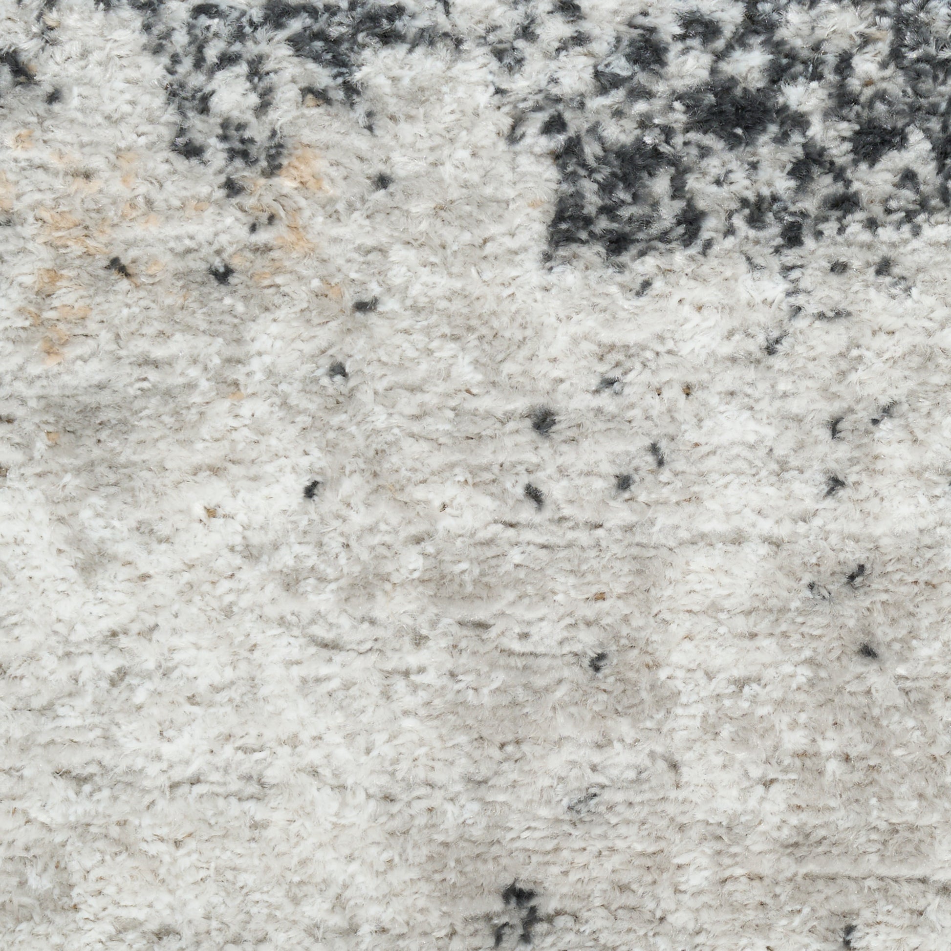 Soft ivory shag rug with cream tones and charcoal speckles, plush pile ideal for living room or bedroom decor.